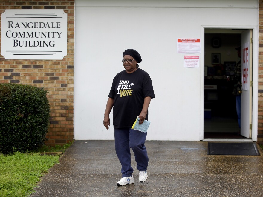 A voter leaves the Rangedale Community Building during the presidential primary in Selma, Ala., on Super Tuesday.