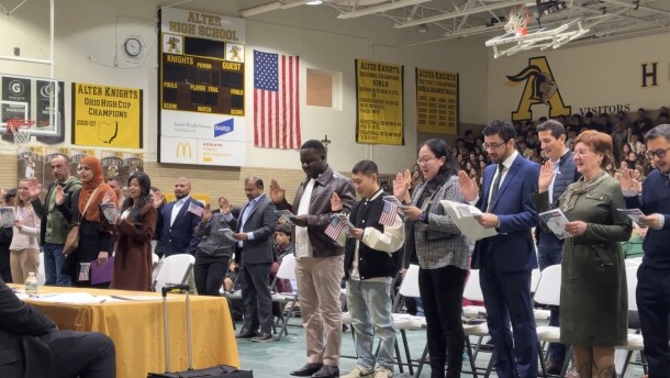 People holding their hand up while giving Oath of Allegiance, the final step to giving citizenship at a ceremony in Kettering on February 12.