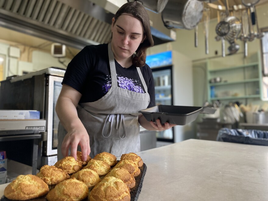 Thomas House Cook Kimmie Holsinger checks the freshly baked corn muffins.