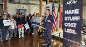 Roy Cooper speaks in front of a podium