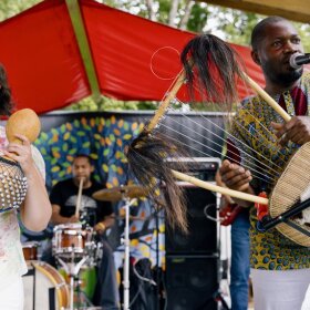 Jordan Scheffer and Ugandan musician Chinobay are front and center of Scheffer's 10-piece band.