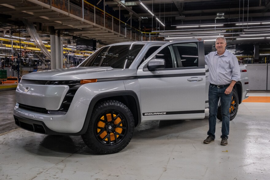 Lordstown Motors CEO Steve Burns stands next to his company's all electric Endurance pickup.