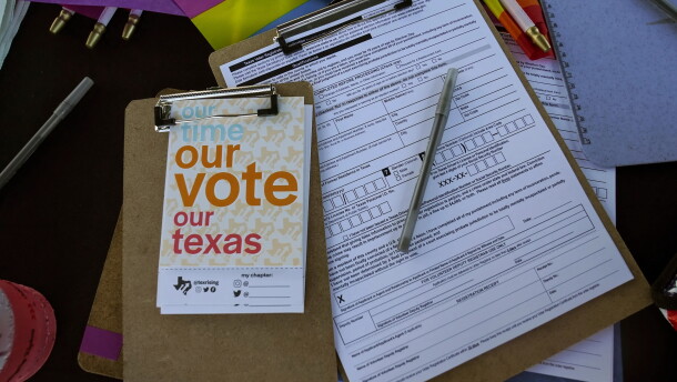 Voter registration applications are seen at the Texas Rising tent during a Pride celebration in Corpus Christi, Texas, on Oct. 5, 2024.