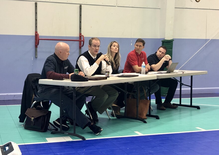 Dr. Dean Forman, founder of John Adams Academy; Joseph Benson, executive director of John Adams Academy; Jenna Hays, president of Classical Quest for Education; Tanner Cropper, secretary of Classical Quest for Education; and Dr. Trevor Peterson, board member of Classical Quest for Education at a Pinehurst School Board meeting on Jan. 25.