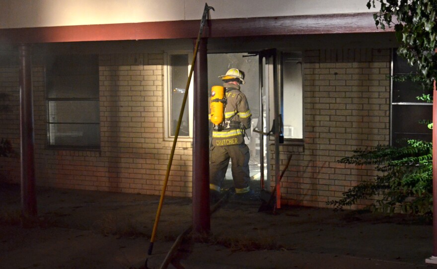 Cooper Volunteer Assistant Fire Tanner Crutcher reenters the structure to ensure the fire is under control.