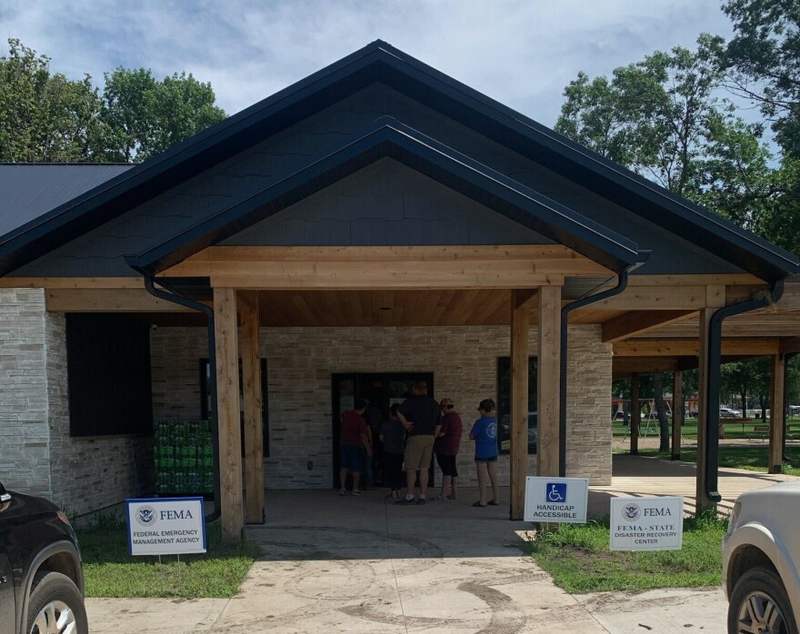 A building with people lined up outside the door.