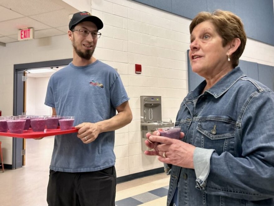 Jacqui McGettigan (R) and Trevor Haggerty (L) present strawberry, banana and blueberry smoothies that are a regular component of second-chance breakfast at Winnisquam Regional High School in Tilton.