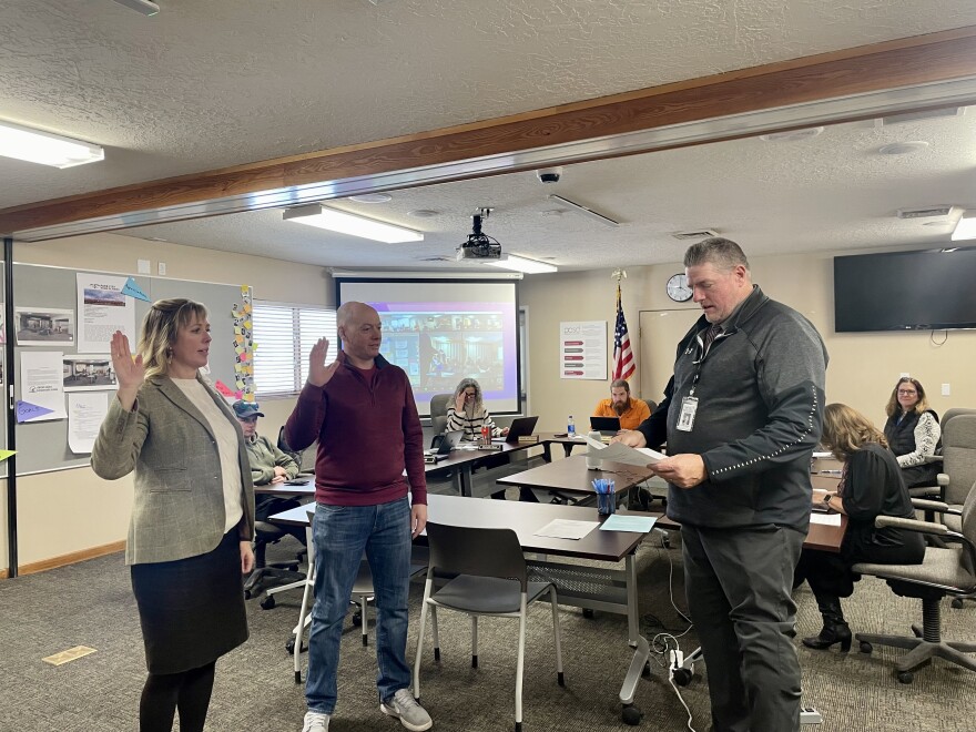 New board members Meredith Reed and Nick Hill were sworn in Tuesday.