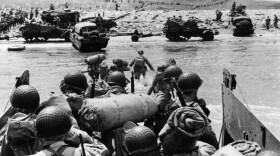 American assault troops and equipment landing on Omaha Beach on the northern coast of France on D-Day. (Fox Photos/Getty Images)