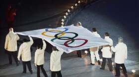 The Olympic flag is carried into Rice-Eccles Olympic Stadium during the opening ceremonies of the 2002 Winter Olympics in Salt Lake City Friday, Feb. 8, 2002.