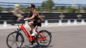 A visitor guides an electric bicycle around a test track at the Electrify Expo, Sunday, July 14, 2024, in north Denver. (David Zalubowski/AP)