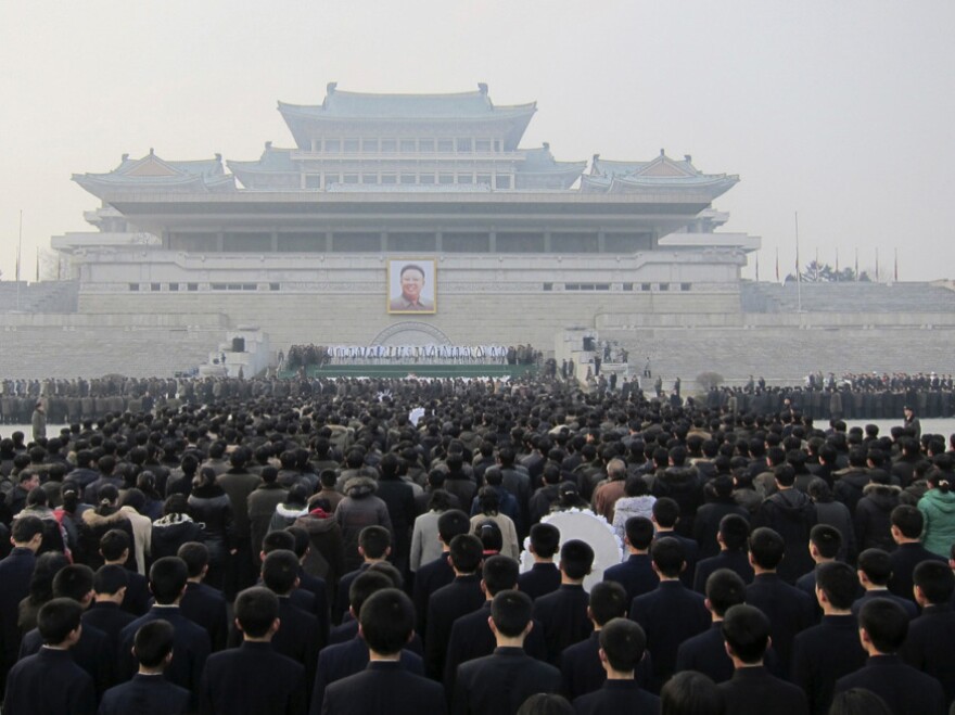 Hundreds of North Koreans queue up to mourn the death of Kim Jong Il in front of a portrait of him in Pyongyang's Kim Il Sung Square on Wednesday. With preparations for next week's state funeral still under way, attention is turning to Kim's son and heir apparent, Kim Jong Un.