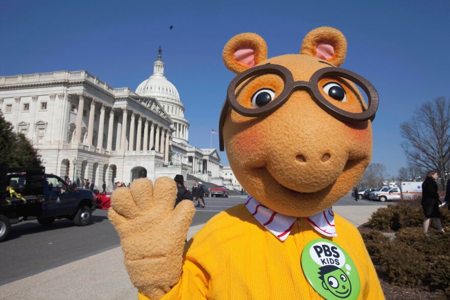 FILE - Arthur the Aardvark waves on Capitol Hill in Washington, Feb. 16, 2011, during a news conference to discuss the future of public broadcasting. (AP Photo/Harry Hamburg, File)