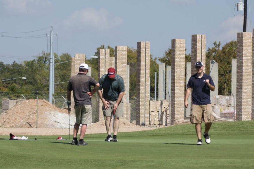 Golfers near the Mueller Substation, which was energized today.