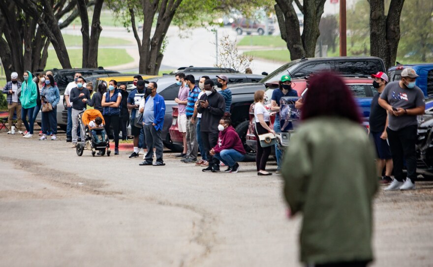 People wait in line at a COVID-19 vaccination clinic.