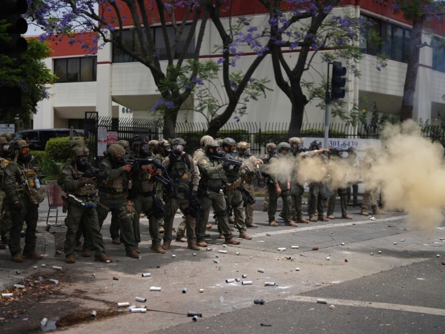 FILE - Border Patrol personnel deploy tear gas during a demonstration over the dozens detained in an operation by federal immigration authorities a day earlier, in Paramount, Calif., June 7, 2025.