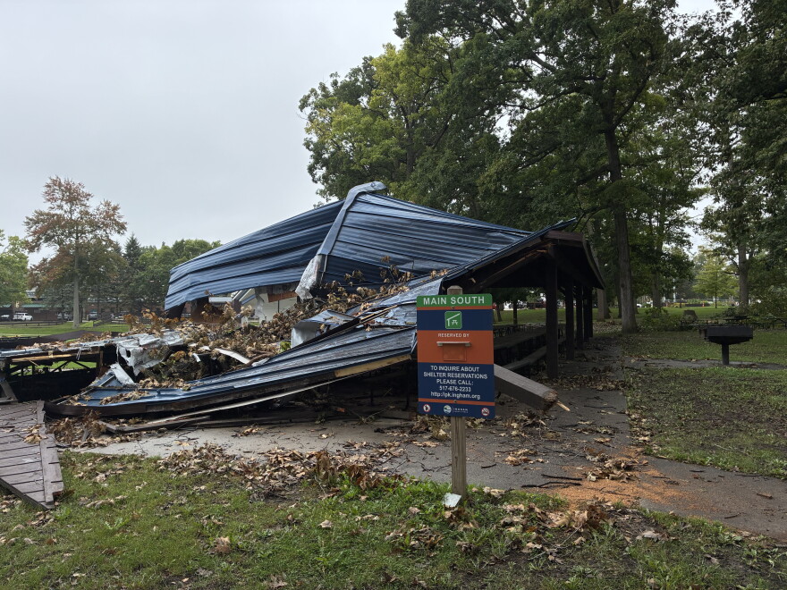 Half crushed park pavilion and a park sign.