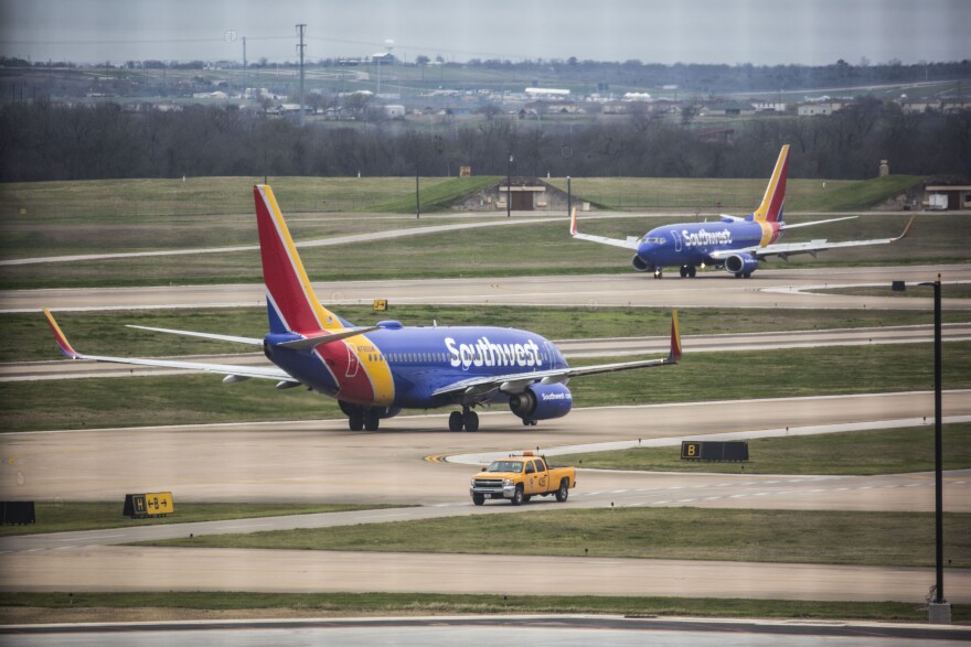 Two Southwest planes taxiing on the airfield at ABIA