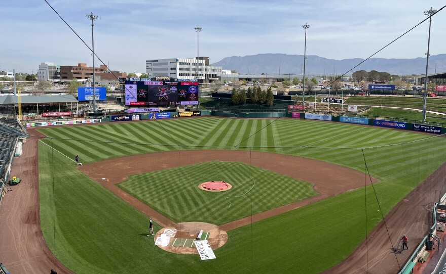 Isotopes staff prepare Rio Grande Credit Union Field for Tuesday's night's season opener against Reno.