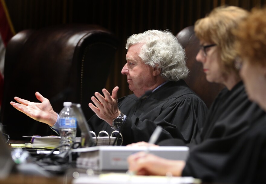 Kansas Supreme Court Justice Dan Biles gesturing from the bench.