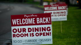 Signs advertising a restaurant reopening after local coronavirus stay-at-home restrictions are lifted.