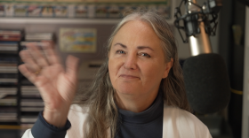 Cordelia Brown waves from a KPR studio during her show, Morning Classical.