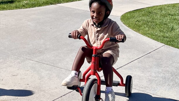 Preschoolers at Spokane's Logan/Lidgerwood Head Start Center ride tricycles during a recess break.