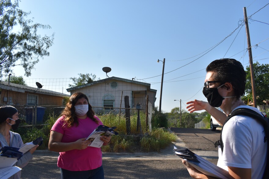 Juan Ruiz shows volunteers homes that lie in the path of Trump's proposed border wall. They handed out flyers to urge residents to vote.
