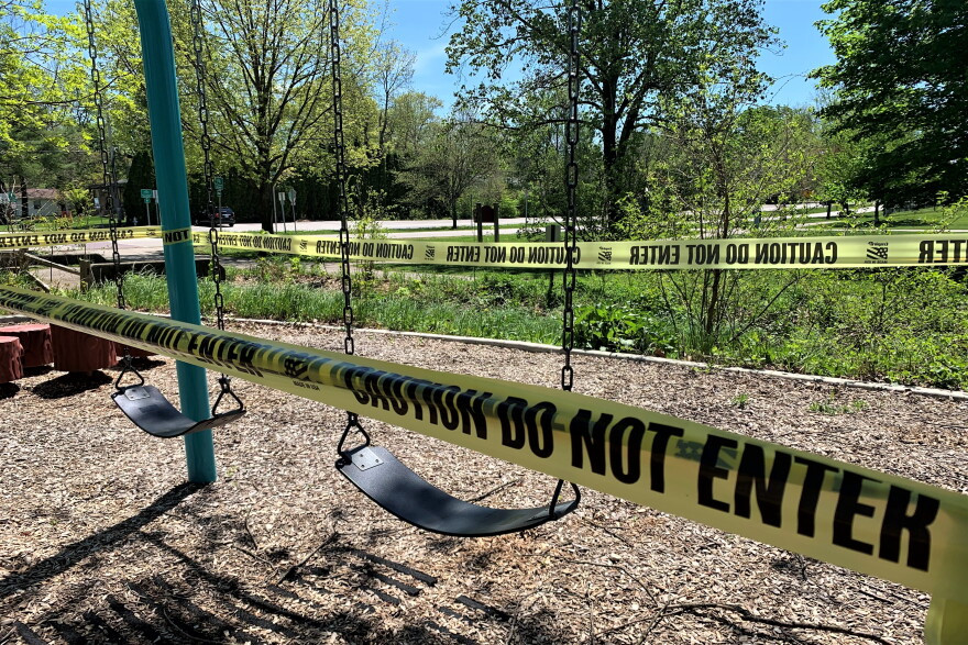 Caution tape cordons off a swing set at Bryan Park in Bloomington amid the coronavirus pandemic.