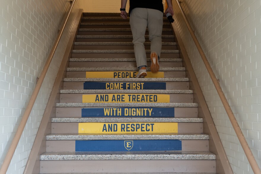 A stairwell in the northwest side of Rogers-Stout Hall on the campus of East Tennessee State University as seen on Wednesday, Nov. 19, 2025 bears a slogan reading, "people come first and are treated with dignity and respect."