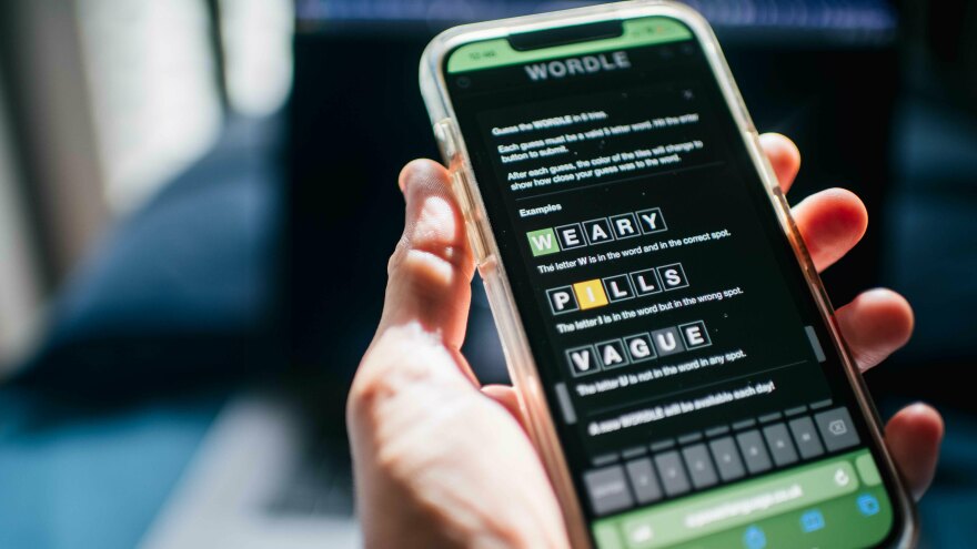 The word game Wordle is shown on a mobile phone in 2022. The <em>New York </em><em>Times </em>is accusing some Wordle clone creators of copyright infringement violations.