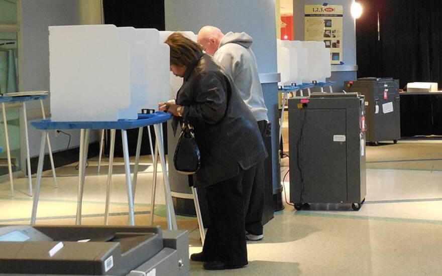 Voters fill out their ballots at the Children's Museum of Indianapolis Tuesday morning.