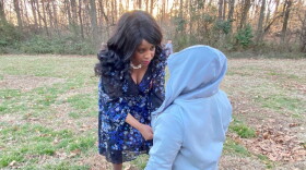 Allenbrook Principal Kimberly Vaught talks to a student on the playground.