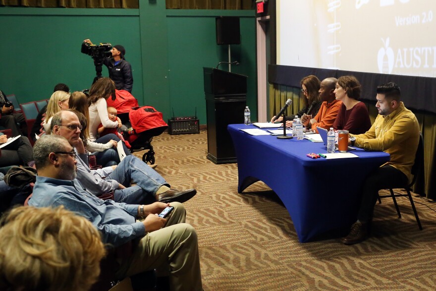 Austin ISD staff talk with members of the community about the second draft of its school closure plan. 