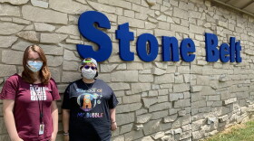 Sage Wright, left, and Mikaela Coppedge, right, stand outside Stone Belt, a nonprofit that supports people with intellectual and developmental disabilities. Coppedge lives and Wright works at Blackstone House, one of Stone Belt's group homes.