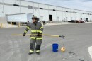 A New Hanover County Firefighter prepares to fry a frozen turkey — a demonstration of what not to do.