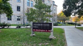 Stone dorm with a couple of bicycles outside. A sign reads "Peddrew-Yates Hall." 