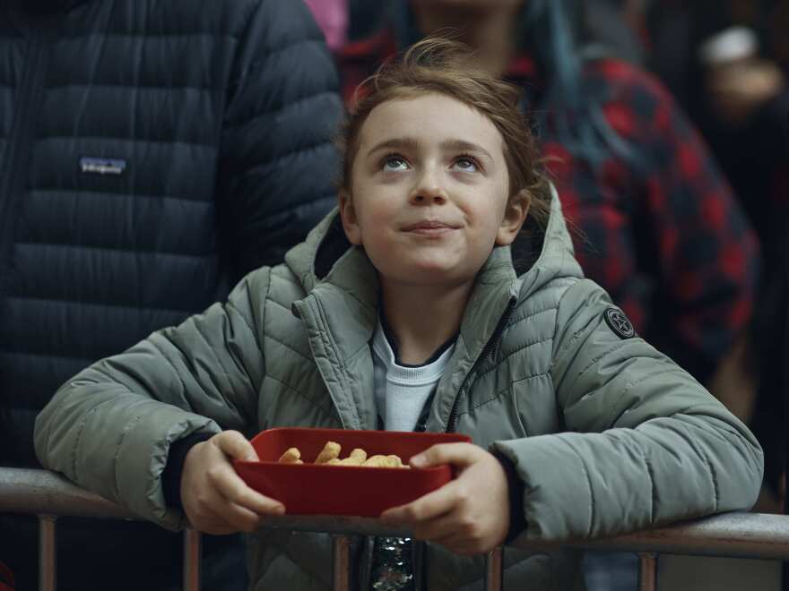 A child watches helium balloons as they're inflated for the Macy's Thanksgiving Day Parade.