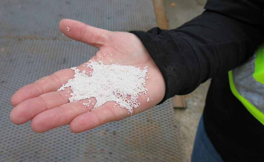 McCahill holds pellets containing carbon dioxide that the company captured from the air.