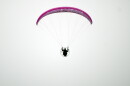 Jake Hutzler flies his paramotor in a clear sky.
