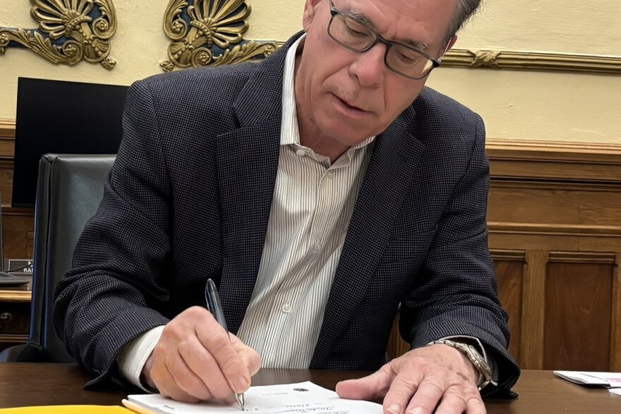 Indiana Gov. Mike Braun signs legislation into law from his Statehouse office on Tuesday, May 6, 2025.