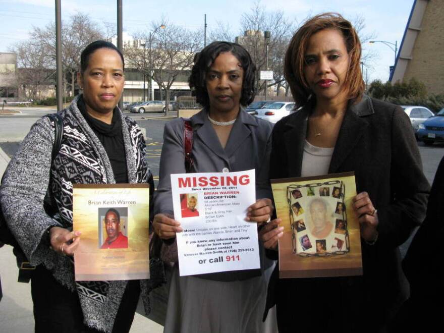 Sisters Bernice Terry (from left), Kim Dent and Sheila Hostetler hold pictures of their brother, Brian Warren, from his memorial service as well as a flier they distributed during the more than two weeks they believed he was missing.