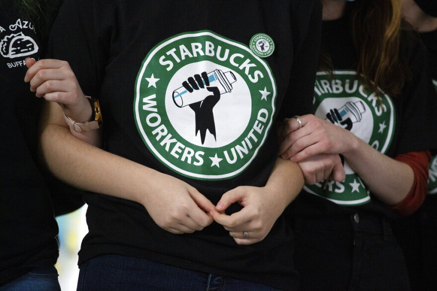FILE - Starbucks employees and supporters react as votes are read during a union-election watch party on Thursday, Dec. 9, 2021, in Buffalo, N.Y. It’s become a common sight: jubilant Starbucks workers celebrating after successful votes to unionize at dozens of U.S. stores. But when the celebrations die down, a daunting hurdle remains. To win the changes they seek, like better pay and more reliable schedules, unionized stores must sit down with Starbucks and negotiate a contract. It’s a painstaking process that can take years. (AP Photo/Joshua Bessex, File)