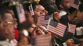 New U.S. citizens wave flags during a special Flag Day naturalization ceremony at the New York Historical Society in New York city.
