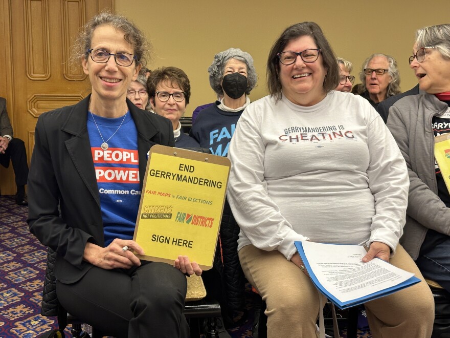 Mia Lewis (left) and Julia Cattaneo (right) sit and wait for the Ohio Redistricting Commission meeting on Oct. 31.