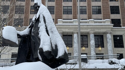 A snow-covered statue of William Henry Seward stands in front of the Alaska State Capitol on Wednesday, March 4, 2026.