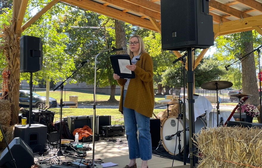 Indivisible Evansville President Wendy Bredhold speaks from the stage at Vote Fest in Evansville's Vann Park, Oct. 18, 2026