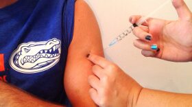 A Gainesville resident receives at a local CVS pharmacy his flu shot, which contains the newest four-strain protection.