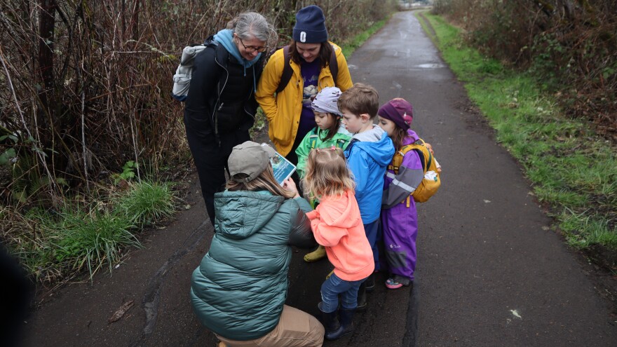 Kendra Callahan teaches a group of children who were walking on Bald Hill Multi-Use Path about beavers.