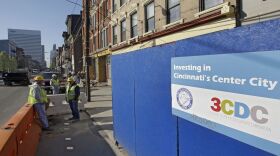 Construction workers stand outside a new building under construction near Vine St. and 14th St. in the Over-the-Rhine neighborhood Thursday, April 9, 2009, in Cincinnati.